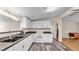 A spacious kitchen featuring white cabinets, stainless steel appliances, and dark countertops at 5062 1St Nw St, Lakeland, FL 33810