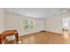 Bright living room featuring wood floors, a window, a white door and neutral walls at 5062 1St Nw St, Lakeland, FL 33810