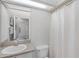 Bathroom with long vanity, toilet, and tub/shower combo with curtain at 507 Eagle Pond Dr # 507, Winter Haven, FL 33884