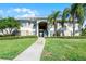 Inviting condo exterior with manicured lawn and lush tropical landscaping at 507 Eagle Pond Dr # 507, Winter Haven, FL 33884