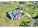 Expansive aerial view of a two-story home with a pool, a gazebo, and a spacious, well-maintained lawn at 5118 Eagles Nest Dr, Lakeland, FL 33810