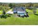 Expansive aerial view showcasing the backyard with a beautiful screened-in pool and a lush green yard at 5118 Eagles Nest Dr, Lakeland, FL 33810