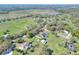 This aerial view reveals a home and lot on green land surrounded by beautiful landscape at 5118 Eagles Nest Dr, Lakeland, FL 33810