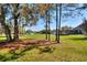 Lush backyard featuring mature trees and a screened-in pool, creating a private oasis for relaxation at 5118 Eagles Nest Dr, Lakeland, FL 33810