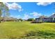 Spacious backyard with lush green grass and a screened-in pool, perfect for outdoor enjoyment and relaxation at 5118 Eagles Nest Dr, Lakeland, FL 33810