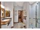 Bathroom featuring tiled floor, vanity with decorative mirror, glass shower, and soaking tub at 5118 Eagles Nest Dr, Lakeland, FL 33810