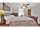 Bright bedroom featuring a decorative ceiling fan, artwork, and hardwood floors at 5118 Eagles Nest Dr, Lakeland, FL 33810