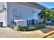 Exterior of the home showcasing the generator and A/C unit on a well-maintained lawn and landscaped area at 5118 Eagles Nest Dr, Lakeland, FL 33810