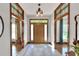 Inviting foyer with tile floors, a decorative rug, a wooden door with sidelights, and stained glass accents at 5118 Eagles Nest Dr, Lakeland, FL 33810