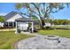 Backyard gazebo with comfortable seating area overlooking a fire pit and landscaping at 5118 Eagles Nest Dr, Lakeland, FL 33810