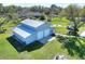 Aerial view of the metal building with roll-up doors and manicured lawn with outdoor fire pit area at 5118 Eagles Nest Dr, Lakeland, FL 33810