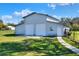 Exterior shot of the metal building with roll-up doors and concrete pathway at 5118 Eagles Nest Dr, Lakeland, FL 33810