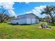 Exterior shot of the metal building with roll-up doors, lawn and outdoor fire pit area at 5118 Eagles Nest Dr, Lakeland, FL 33810