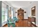 Bright sitting room with hardwood floors, floral chairs, and a decorative hutch at 5118 Eagles Nest Dr, Lakeland, FL 33810