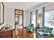 Sitting room featuring hardwood floors, floral chairs, and a decorative hutch at 5118 Eagles Nest Dr, Lakeland, FL 33810