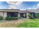 View of the backyard including a screened in patio, green grass, and home exterior at 5225 Imperial Lakes Blvd # 49, Mulberry, FL 33860