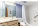Well-lit bathroom with blue accent wall, white sink and cabinetry, plus tub and shower at 5225 Imperial Lakes Blvd # 49, Mulberry, FL 33860