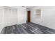 Bright bedroom features neutral walls, modern gray wood flooring, closet and natural light at 5225 Imperial Lakes Blvd # 49, Mulberry, FL 33860
