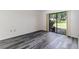 Comfortable bedroom with wide plank flooring and a sliding glass door providing backyard access at 5225 Imperial Lakes Blvd # 49, Mulberry, FL 33860