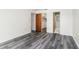Bright bedroom features neutral walls, modern gray wood flooring, and ample closet space at 5225 Imperial Lakes Blvd # 49, Mulberry, FL 33860