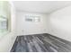 Bright bedroom features neutral walls, modern gray wood flooring, and natural light at 5225 Imperial Lakes Blvd # 49, Mulberry, FL 33860