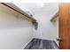 Walk-in closet with gray wood flooring, white walls, shelving and hanging storage space at 5225 Imperial Lakes Blvd # 49, Mulberry, FL 33860