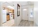 Inviting entryway features tile flooring, a white door, and a partial view of the kitchen at 5225 Imperial Lakes Blvd # 49, Mulberry, FL 33860