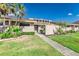 Inviting single story home featuring lush landscaping, a walkway, and a light beige exterior at 5225 Imperial Lakes Blvd # 49, Mulberry, FL 33860