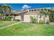 Inviting single story home featuring lush landscaping, a walkway, and a light beige exterior at 5225 Imperial Lakes Blvd # 49, Mulberry, FL 33860