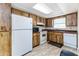 Functional kitchen features white appliances, tiled floor, and light-colored wooden cabinetry at 5225 Imperial Lakes Blvd # 49, Mulberry, FL 33860