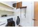 Bright laundry room with washer, dryer, storage shelving and wood vinyl flooring at 5225 Imperial Lakes Blvd # 49, Mulberry, FL 33860