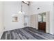 Spacious living room features a wet bar, vaulted ceilings, and wide plank flooring at 5225 Imperial Lakes Blvd # 49, Mulberry, FL 33860