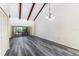 Spacious living room featuring vaulted ceilings with exposed beams and wide plank flooring at 5225 Imperial Lakes Blvd # 49, Mulberry, FL 33860