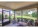View of a screened in patio with chairs overlooking the lush green yard at 5225 Imperial Lakes Blvd # 49, Mulberry, FL 33860