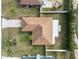 An aerial perspective of the home showing the roof, lot, and a partial view of the neighborhood and surrounding landscape at 5252 Montserrat Dr, Lakeland, FL 33812