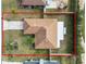 An aerial perspective of the home showing the roof, lot, and a partial view of the neighborhood and surrounding landscape at 5252 Montserrat Dr, Lakeland, FL 33812