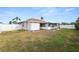 Backyard with a white fence, green grass, and view of the back of the home at 5252 Montserrat Dr, Lakeland, FL 33812