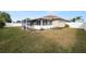 Grassy backyard with an enclosed porch and a white perimeter fence at 5252 Montserrat Dr, Lakeland, FL 33812