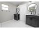 Bathroom featuring dual vanities with marble countertops and modern round mirrors at 5252 Montserrat Dr, Lakeland, FL 33812