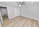 Bedroom with wood-look flooring features a closet, ceiling fan, and neutral paint at 5252 Montserrat Dr, Lakeland, FL 33812