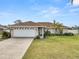 Inviting single-story home featuring a well-manicured lawn, a two-car garage, and lush landscaping at 5252 Montserrat Dr, Lakeland, FL 33812