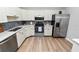 Modern kitchen featuring stainless steel appliances, white cabinets, and stylish backsplash at 5252 Montserrat Dr, Lakeland, FL 33812