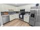 Well-lit kitchen featuring stainless steel appliances, light cabinets, and a stylish backsplash at 5252 Montserrat Dr, Lakeland, FL 33812