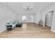 Bright living room with wood-look flooring, neutral paint, and modern light fixture at 5252 Montserrat Dr, Lakeland, FL 33812