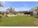 A wide view of the backyard with a pool, windmill and home architecture at 531 Gibson S Rd, Lakeland, FL 33813