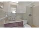 This bathroom features a shower-tub combo with a dark vanity and sink at 531 Gibson S Rd, Lakeland, FL 33813