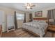 Comfortable bedroom with ceiling fan, wood floors, and a decorative accent wall at 531 Gibson S Rd, Lakeland, FL 33813