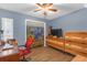 This bedroom features a ceiling fan, wooden dresser, and laminate floors at 531 Gibson S Rd, Lakeland, FL 33813