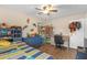 This bedroom features a ceiling fan, colorful decorations, and laminate floors at 531 Gibson S Rd, Lakeland, FL 33813