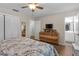 This bedroom features a ceiling fan, a wooden dresser, and an ensuite bathroom at 531 Gibson S Rd, Lakeland, FL 33813